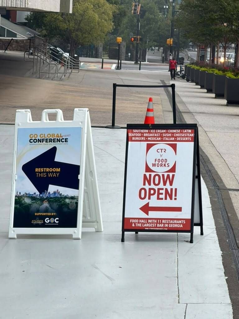 Directional sidewalk A-frame sign at a conference